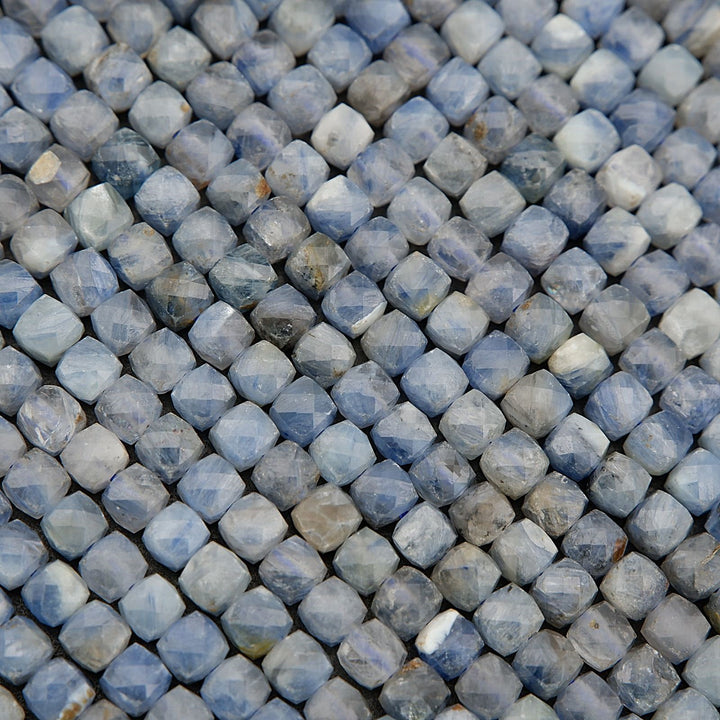 Close-up of blue and gray faceted beads arranged in a pattern