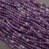 Close-up of purple beads on a gray background