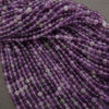 Close-up of purple beads on a gray background
