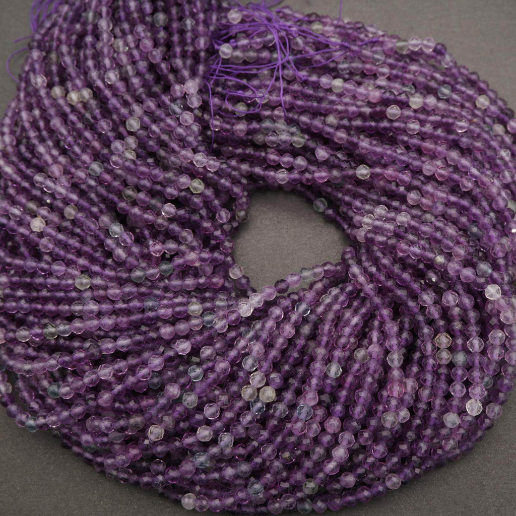 Close-up of a spool of purple thread on a gray background