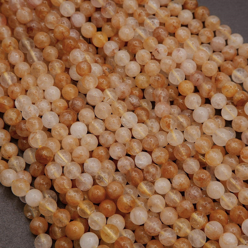 Close-up of amber-colored beads on a gray background