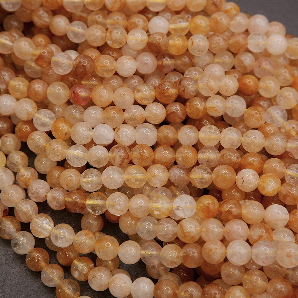 Close-up of amber-colored beads on a gray background