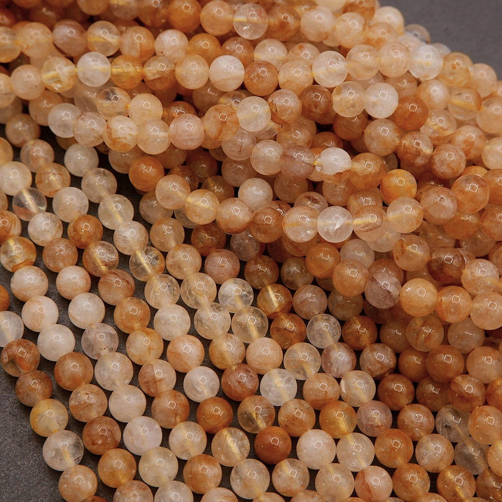 Close-up of amber-colored beads on a gray background