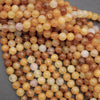 Close-up of multicolored round beads on a gray background