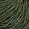 Close-up of green beads on a dark background