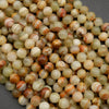Yellowish green round beads with brown banding.
