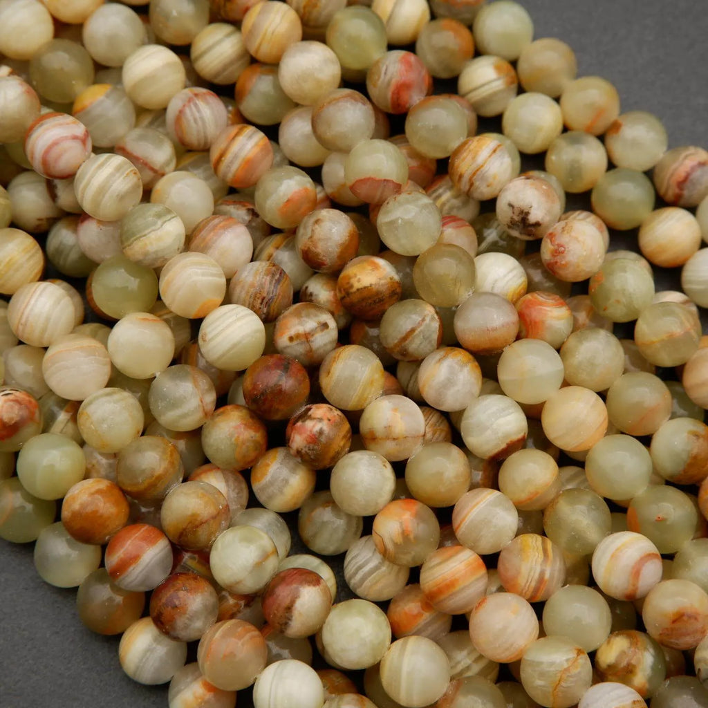 Yellowish green round beads with brown banding.