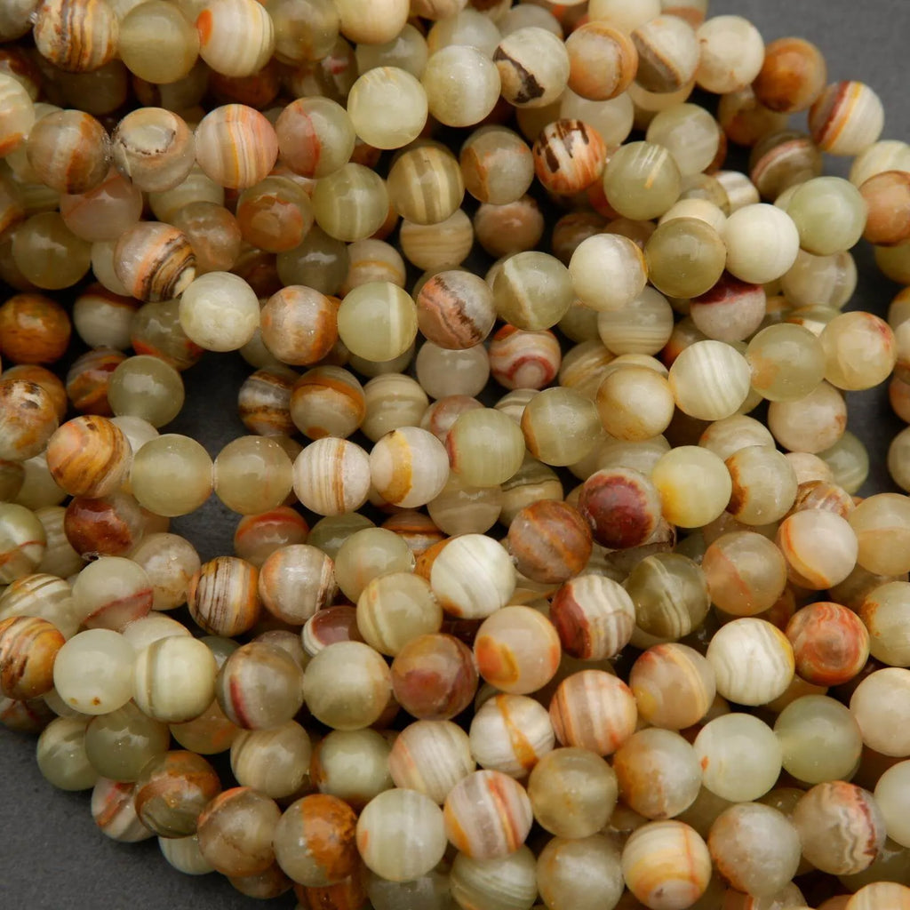 Yellowish green round beads with brown banding.