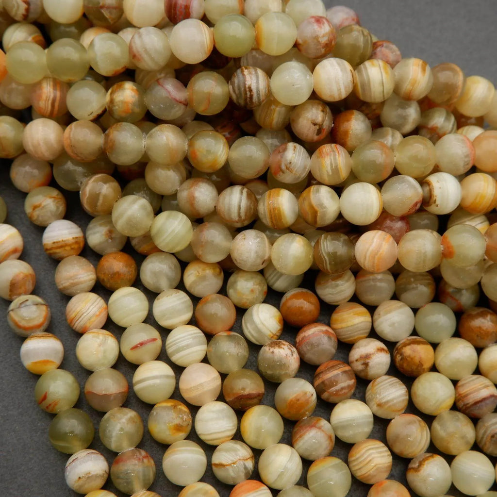 Yellowish green round beads with brown banding.