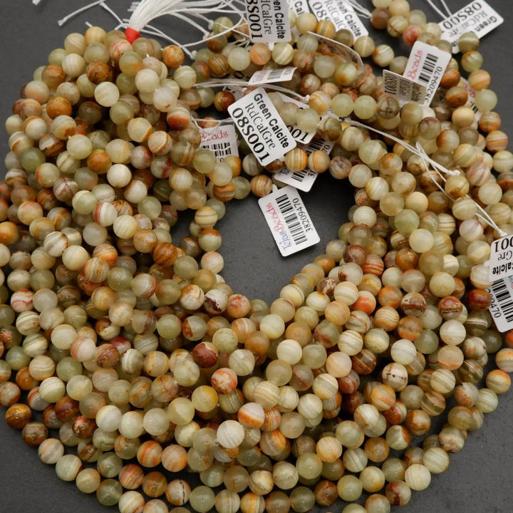 Yellowish green round beads with brown banding.
