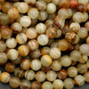 Yellowish green round beads with brown banding.