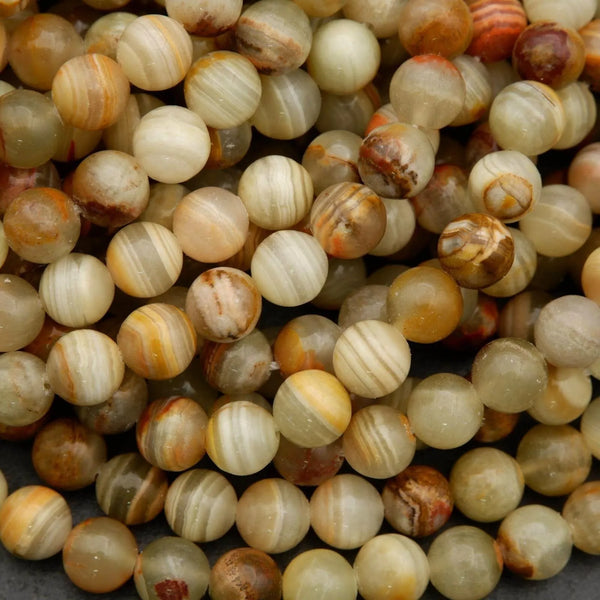 Yellowish green round beads with brown banding.