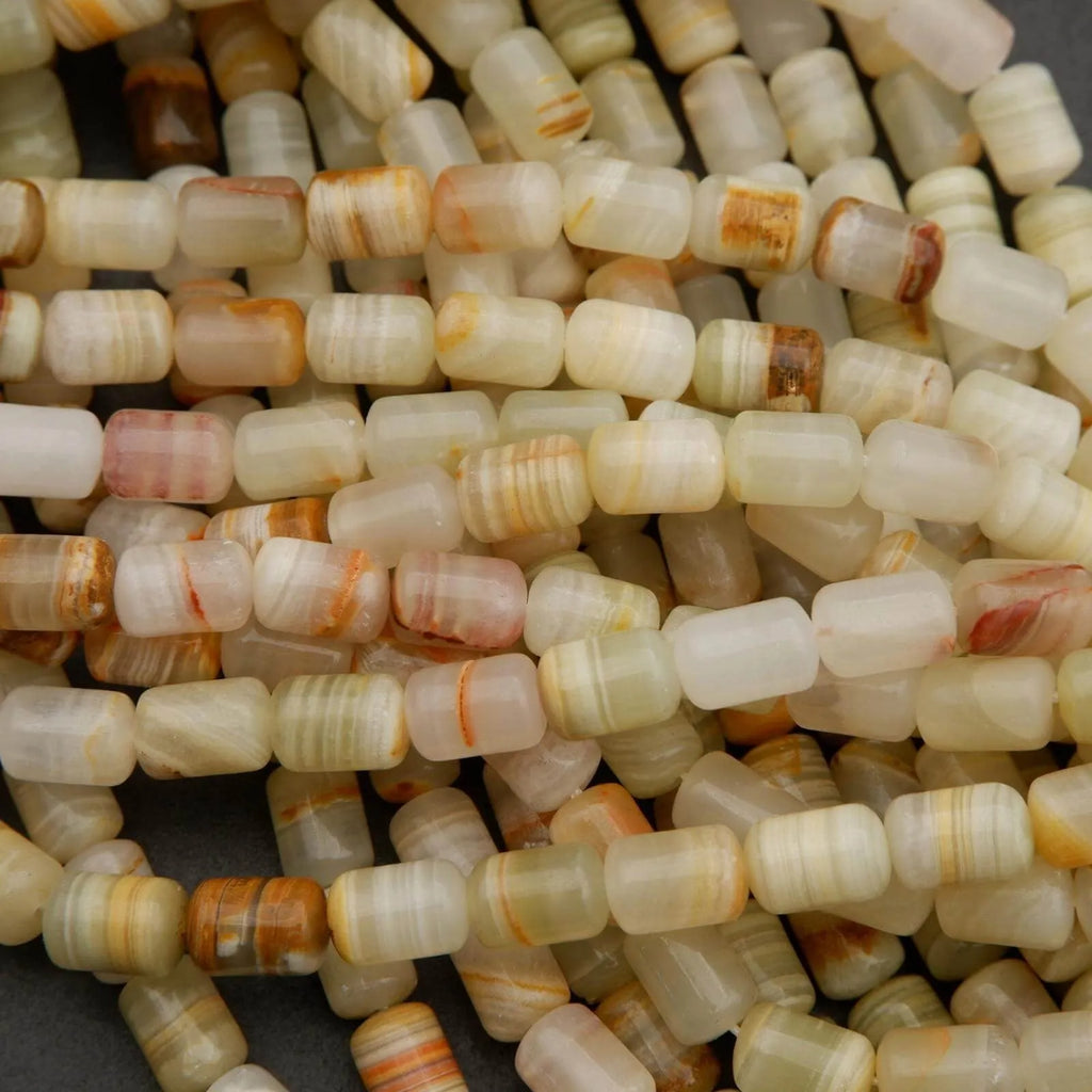 Natural calcite gemstone beads featuring layered patterns of green, ivory, and warm brown