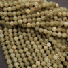 Close-up of greenish-beige beads on a dark background