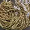 Green beads with labels on a dark surface