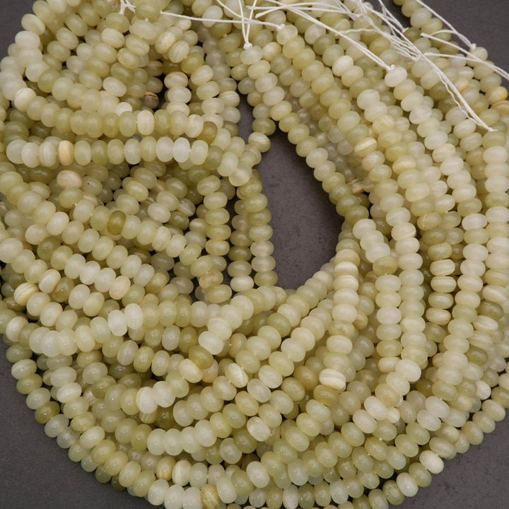 Close-up of a string of light green beads on a gray background