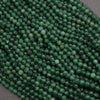 Close-up of green beads on a dark background