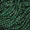 Close-up of green beads with a faceted surface