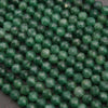 Close-up of green beads on a dark background
