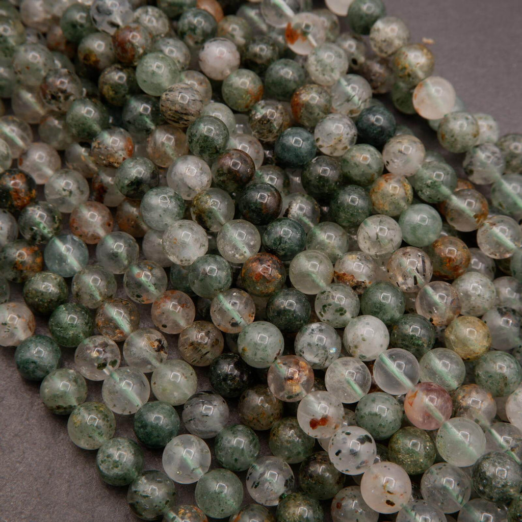 Close-up of green and brown beaded strands on a gray background