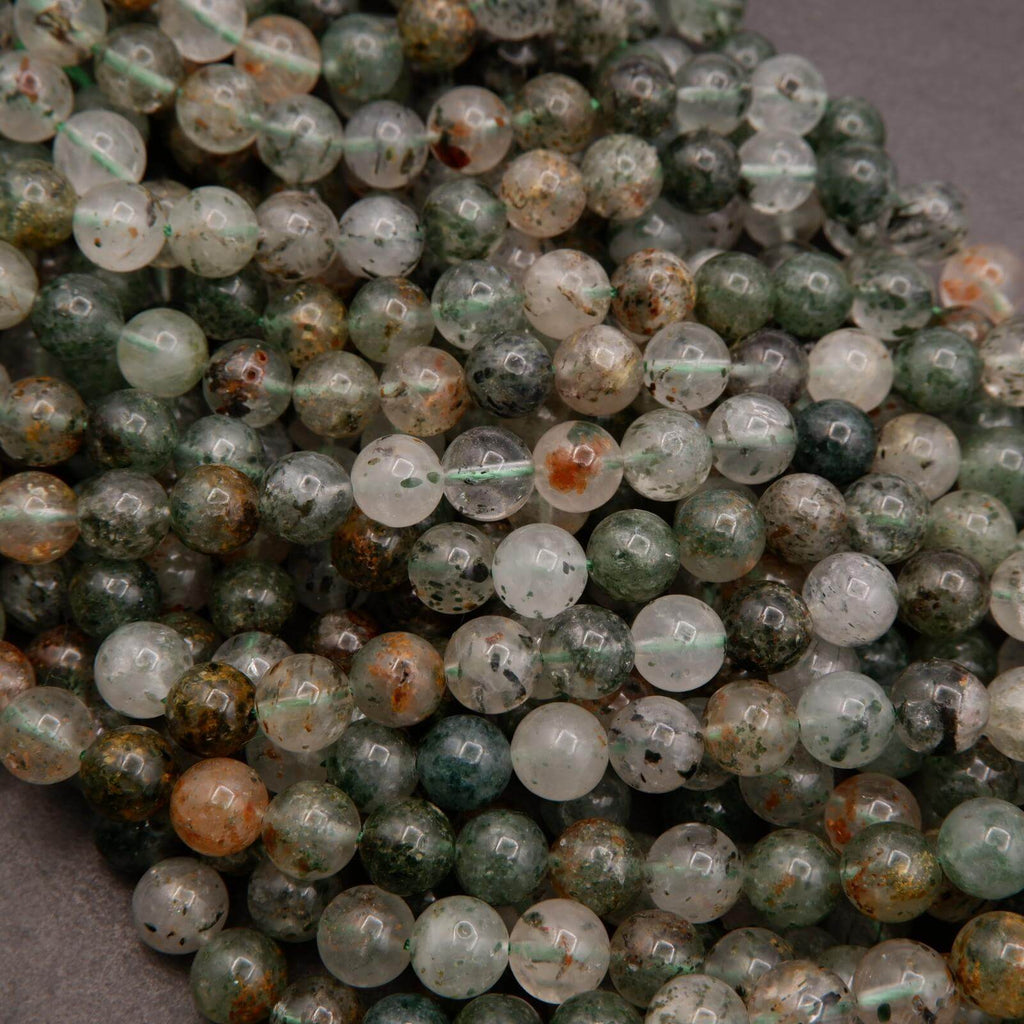 Close-up of green and brown marbled beads on a string.