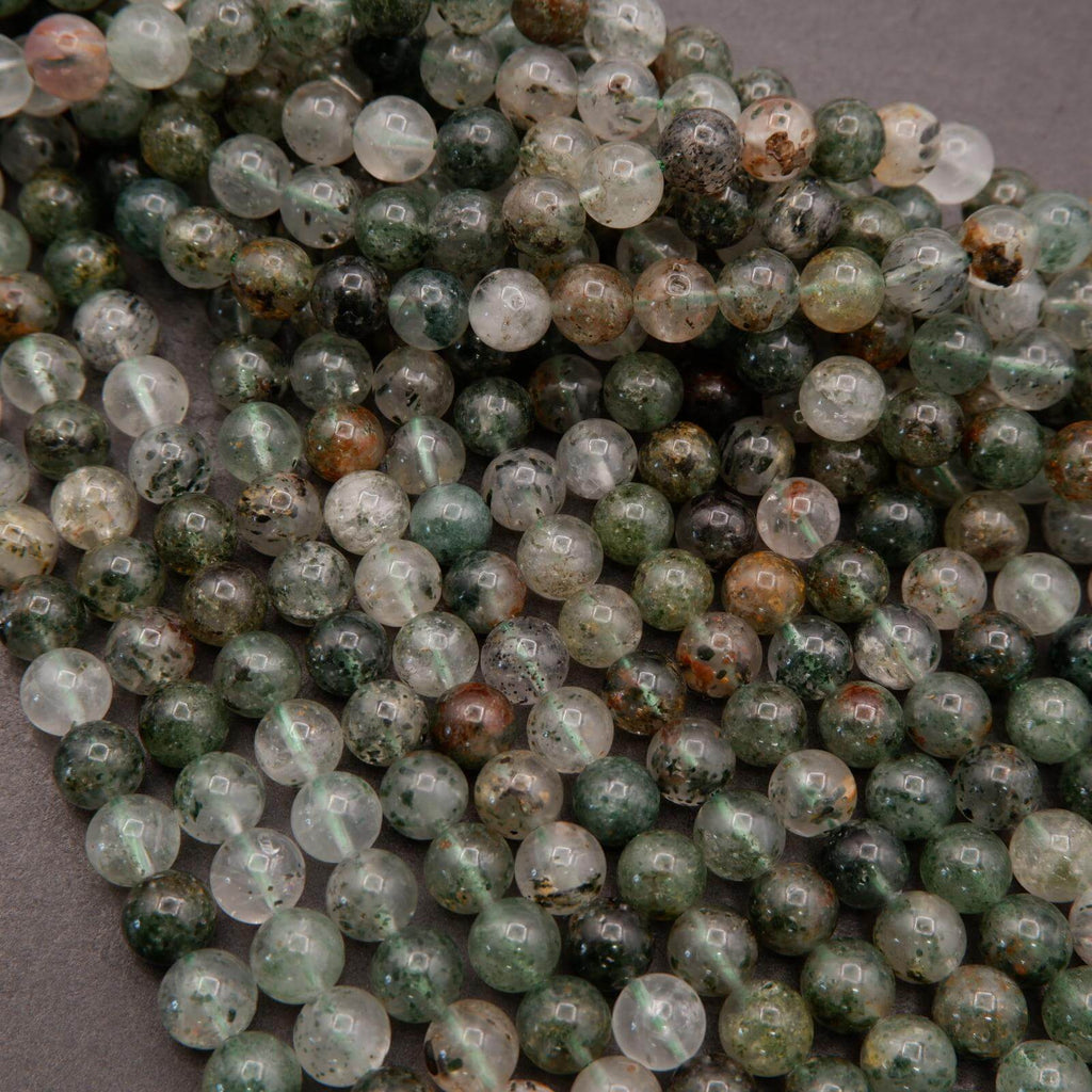 Close-up of green and brown marbled beads on a gray background