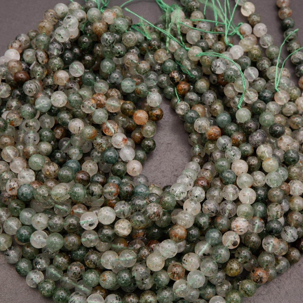 String of green and brown beads on a gray surface