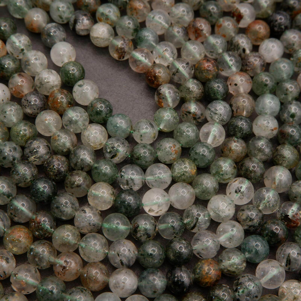 Close-up of green and white beads on a gray background
