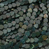 Close-up of heart-shaped green stones with a dark background