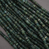 String of green beads on a gray background