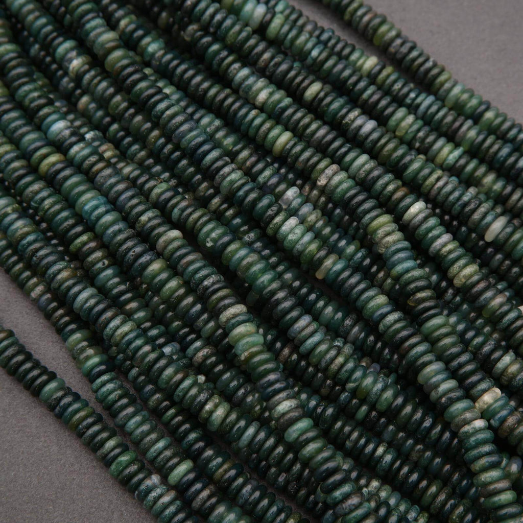 String of green beads on a gray background