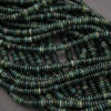 Close-up of green beads on a dark background