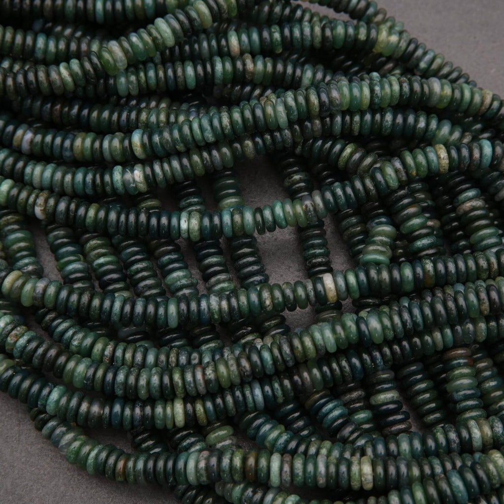 Close-up of green beads on a dark background