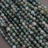 Close-up of green and white marbled beads on a dark background
