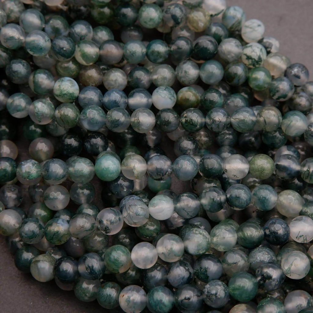 Close-up of green and white marbled beads on a dark background