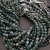Green beads with price tags on a dark surface