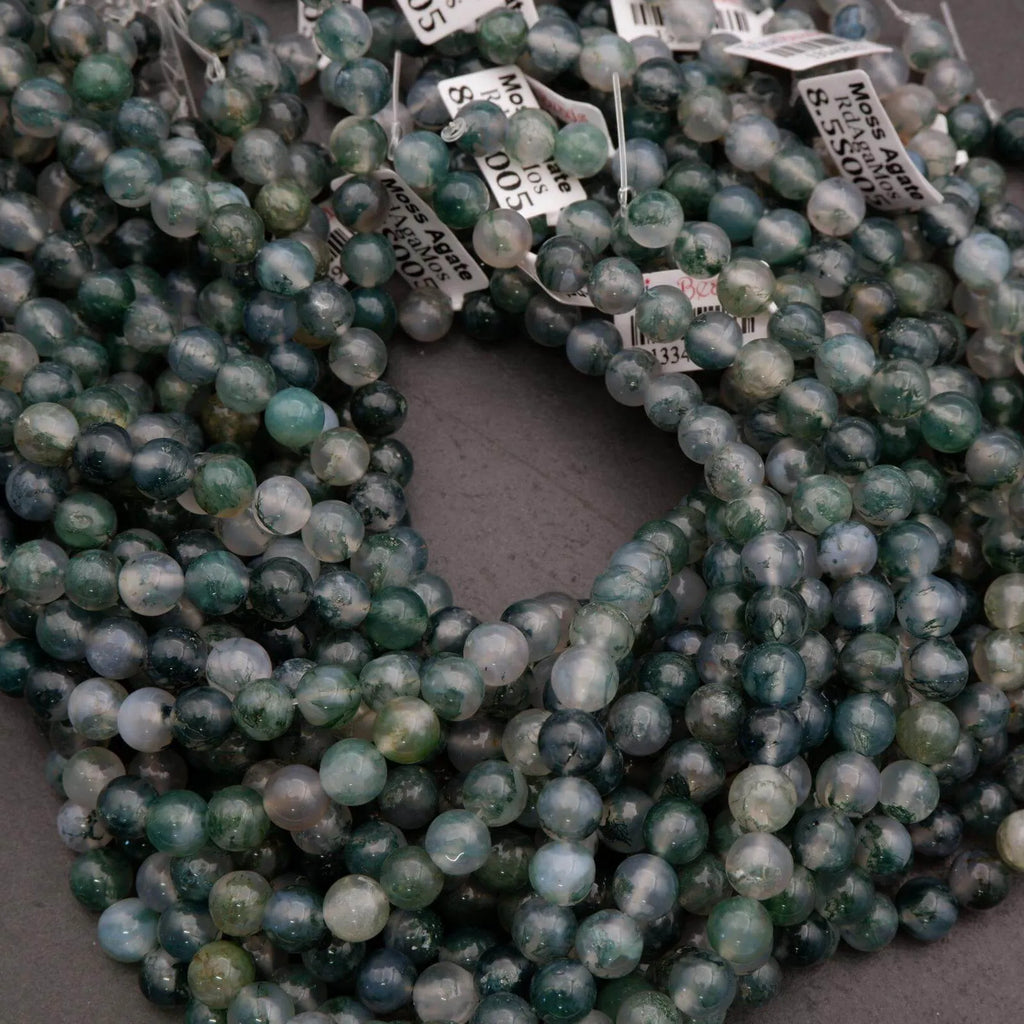 Green beads with price tags on a dark surface