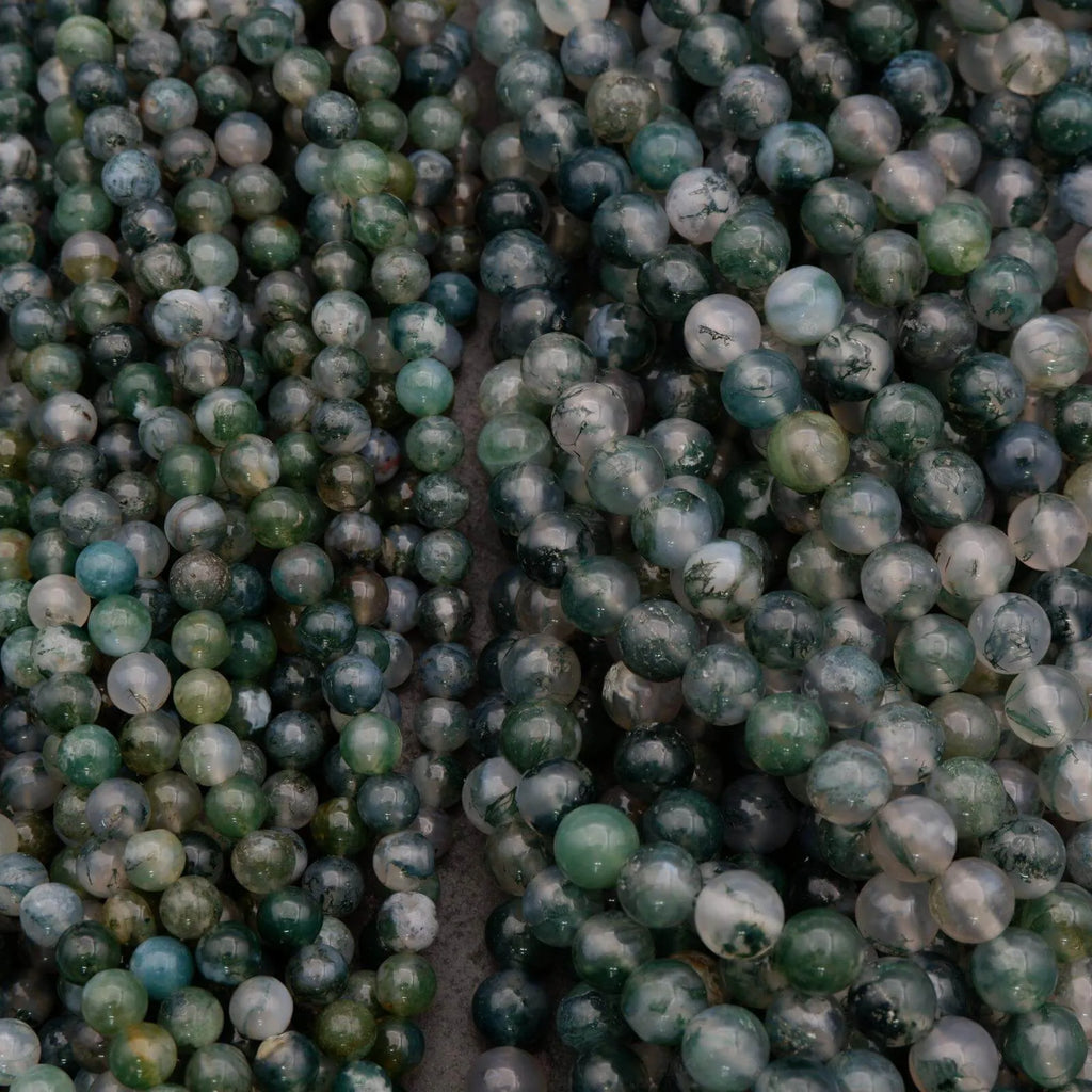 Close-up of green and gray beads on a string