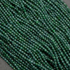 Tiny faceted green beads on a string.