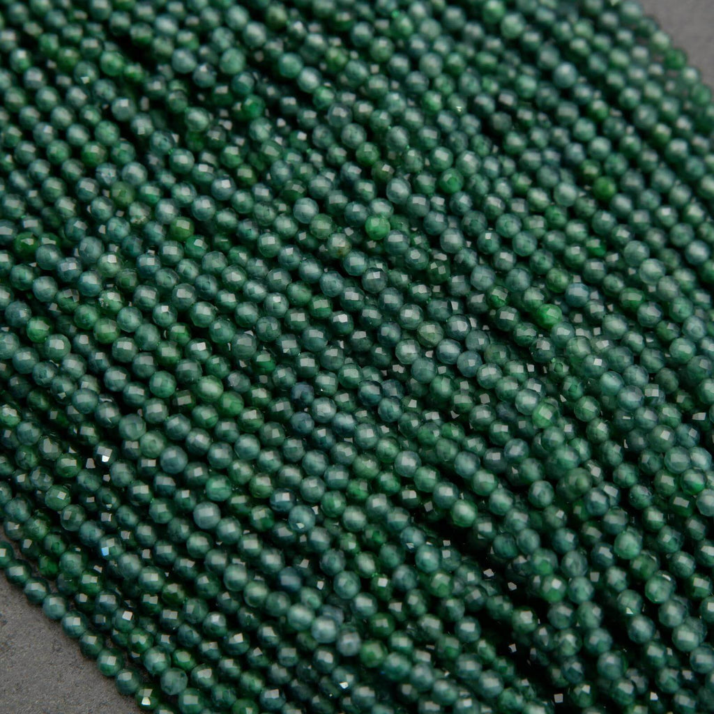Tiny faceted green beads on a string.