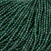 Tiny faceted green beads on a string.