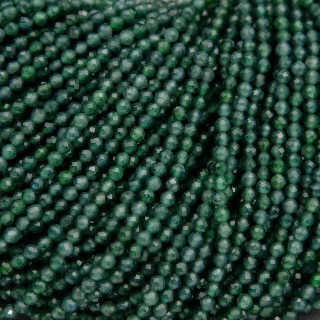 Tiny faceted green beads on a string.