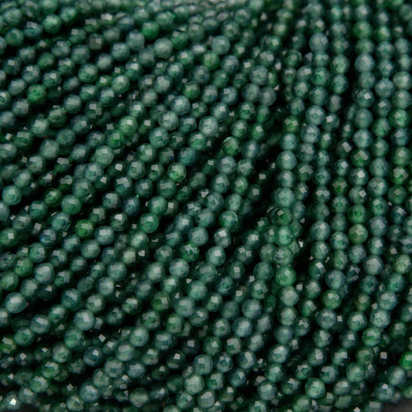 Tiny faceted green beads on a string.