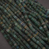 Close-up of green and blue beads on a dark background