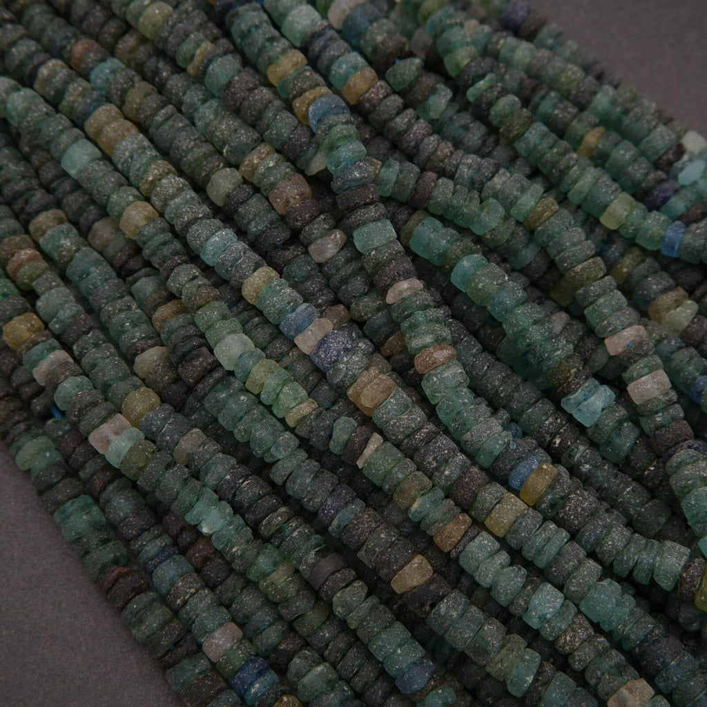 Close-up of green and blue beads on a dark background