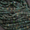 Close-up of a string of green and blue beads.