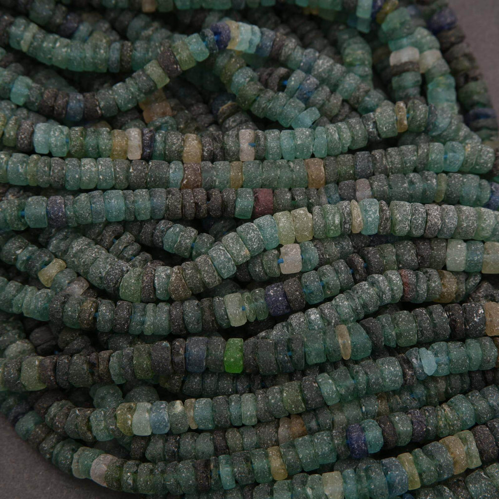 Close-up of a string of green and blue beads.