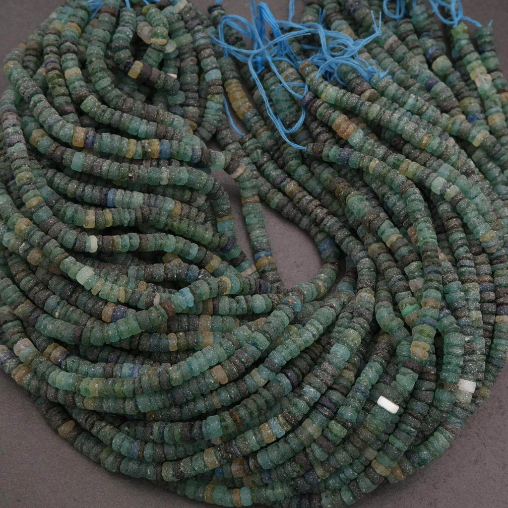 String of green beads on a gray surface