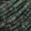 Close-up of green and brown beaded strands