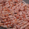 Close-up of pink and red beads on a dark background